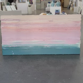 A video of a peach, orange, coral, pale pink and teal thickly textured abstract painting leaning in the Sorelle Gallery.