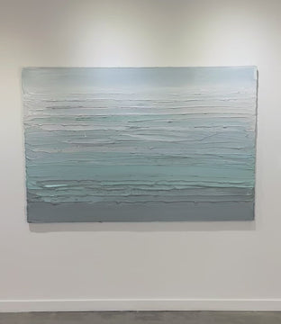 A video of a white, teal and grey heavily textured abstract painting like sculpture by Teodora Guererra hangs on a white wall in natural light.