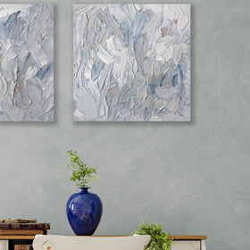 A painting is hanging on a wall. Its surface is decorated with white, blue and grey paint in a thick impasto. Hangs over a desk with rotary dial phone. Wired and ready to hang.