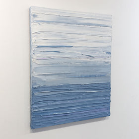 A painting is shown hanging on the wall at an angle. Its surface is decorated with blue and white paint in thick impasto streaks. Wired and ready to hang.