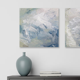 A painting is hanging on a wall over a dark brown mid century modern table with a sea-foam green vase and books on it. Its surface is decorated with white, blue and green paint in a thick impasto. Wired and ready to hang.