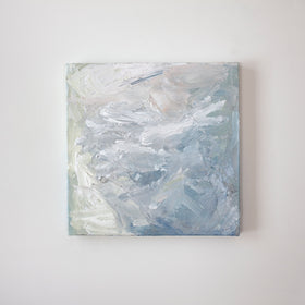 A painting is hanging on a wall. Its surface is decorated with white, blue and green paint in a thick impasto. Wired and ready to hang.