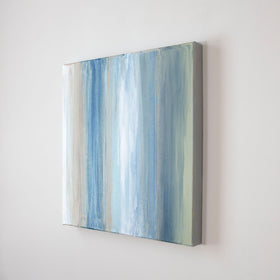 A blue, white and green streaked tan canvas is seen from an angle. Wired and ready to hang.